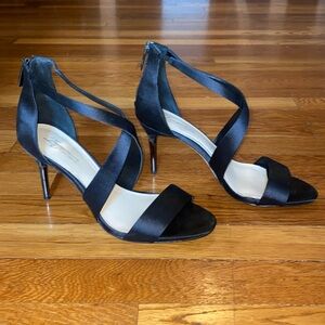 Size 8.5 women’s Vince Camuto black heels with a crisscross front.